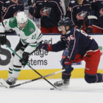 
              Dallas Stars' Radek Faksa, left, carries the puck across the blue line past Columbus Blue Jackets' Jack Roslovic during the third period of an NHL hockey game on Monday, Dec. 19, 2022, in Columbus, Ohio. (AP Photo/Jay LaPrete)
            