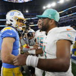 
              Los Angeles Chargers quarterback Justin Herbert (10) shakes hands with Miami Dolphins quarterback Tua Tagovailoa after an NFL football game Sunday, Dec. 11, 2022, in Inglewood, Calif. (AP Photo/Jae C. Hong)
            