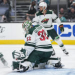 
              Minnesota Wild goaltender Filip Gustavsson (32) deflects a shot against the San Jose Sharks during the second period of an NHL hockey game in San Jose, Calif., Thursday, Dec. 22, 2022. (AP Photo/Godofredo A. Vásquez)
            