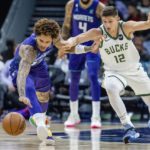 
              Charlotte Hornets guard Kelly Oubre Jr., left, and Milwaukee Bucks guard Grayson Allen fo after the ball during the first half of an NBA basketball game Saturday, Dec. 3, 2022, in Charlotte, N.C. (AP Photo/Scott Kinser)
            