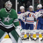 
              Dallas Stars goaltender Jake Oettinger, left, stands by the net as Edmonton Oilers' Ryan Nugent-Hopkins, left rear, Evan Bouchard, center rear, and Klim Kostin celebrate a score by Nugent-Hopkins in the second period of an NHL hockey game, Wednesday, Dec. 21, 2022, in Dallas. (AP Photo/Tony Gutierrez)
            