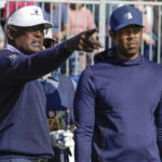 
              Vijay Singh, right, and his son Qass Sing, left, talk before teeing off the first hole during the first round of the PNC Championship golf tournament Saturday, Dec. 17, 2022, in Orlando, Fla. (AP Photo/Kevin Kolczynski)
            