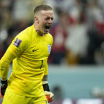 
              England's goalkeeper Jordan Pickford celebrates after teammate Harry Kane scored their side's first goal from the penalty spot during the World Cup quarterfinal soccer match between England and France, at the Al Bayt Stadium in Al Khor, Qatar, Saturday, Dec. 10, 2022. (AP Photo/Francisco Seco)
            