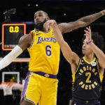 
              Indiana Pacers guard Andrew Nembhard, right, makes a buzzer beating 3-point shot to win the game as Los Angeles Lakers forward LeBron James defends during the second half of an NBA basketball game Monday, Nov. 28, 2022, in Los Angeles. The Pacers won 116-115. (AP Photo/Mark J. Terrill)
            