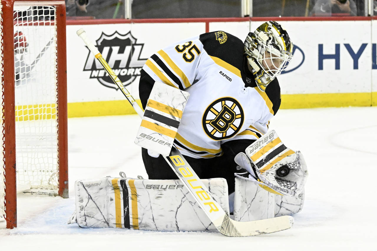 Boston Bruins goaltender Linus Ullmark (35) gloves the puck during the second period of an NHL hock...