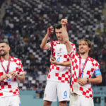 
              Croatia's Luka Modric, right, Ivan Perisic, center, and Mateo Kovacic celebrate with their medals after the World Cup third-place playoff soccer match between Croatia and Morocco at Khalifa International Stadium in Doha, Qatar, Saturday, Dec. 17, 2022. Croatia won 2-1. (AP Photo/Hassan Ammar)
            