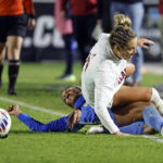 
              Alabama's Ashlynn Serepca, top, is taken down by UCLA's Sunshine Fontes during the first half of an NCAA women's soccer tournament semifinal in Cary, N.C., Friday, Dec. 2, 2022. (AP Photo/Karl B DeBlaker)
            