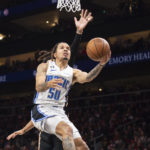 
              Orlando Magic guard Cole Anthony (50) scores during the second half of an NBA basketball game against the Atlanta Hawks, Monday, Dec. 19, 2022, in Atlanta. (AP Photo/Hakim Wright Sr.)
            