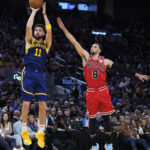 
              Golden State Warriors guard Klay Thompson (11) shoots next to Chicago Bulls guard Zach LaVine (8) during the first half of an NBA basketball game in San Francisco, Friday, Dec. 2, 2022. (AP Photo/Godofredo A. Vásquez)
            