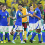
              Brazilian players greet each other at the end of the World Cup group G soccer match between Cameroon and Brazil, at the Lusail Stadium in Lusail, Qatar, Friday, Dec. 2, 2022. Cameroon won 1-0. (AP Photo/Andre Penner)
            