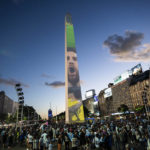 
              Argentine soccer fans gather at the Obelisk landmark illuminated with an image of soccer star Lionel Messi, during a rally in support of the national soccer team, a day ahead of the World Cup final against France, in Buenos Aires, Argentina, Saturday, Dec. 17, 2022.  (AP Photo/Rodrigo Abd)
            