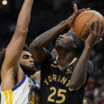 
              Toronto Raptors forward Chris Boucher (25) looks for an angle as Golden State Warriors forward Anthony Lamb (40) defends during the first half of an NBA basketball game in Toronto, Sunday, Dec. 18, 2022. (Frank Gunn/The Canadian Press via AP)
            