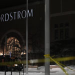 
              Caution tape and police cars are seen outside Nordstrom at Mall of America after a shooting, Friday, Dec. 23, 2022, in Bloomington, Minn. (AP Photo/Abbie Parr)
            