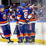 
              New York Islanders left wing Anders Lee (27), defenseman Noah Dobson (8) and others celebrate center Mathew Barzal's (13) goal during the third period of an NHL hockey game against the Nashville Predators, Friday, Dec. 2, 2022, in Elmont, N.Y. (AP Photo/Julia Nikhinson)
            