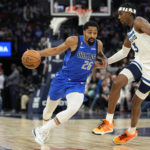 
              Dallas Mavericks guard Spencer Dinwiddie (26) works toward the basket while defended by Minnesota Timberwolves forward Jaden McDaniels (3) during the second half of an NBA basketball game, Monday, Dec. 19, 2022, in Minneapolis. (AP Photo/Abbie Parr)
            