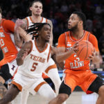 
              Illinois' Jayden Epps (3) eyes the basket against Texas' Marcus Carr (5) in overtime during the team's NCAA college basketball game in the Jimmy V Classic, Tuesday, Dec. 6, 2022, in New York. (AP Photo/John Minchillo)
            