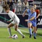
              North Carolina's Avery Patterson (15) moves the ball after taking it from Florida State's Heather Payne, left, during the first half of an NCAA women's soccer tournament semifinal in Cary, N.C., Friday, Dec. 2, 2022. (AP Photo/Karl B DeBlaker)
            