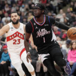 
              Los Angeles Clippers guard Reggie Jackson (1) drives past Toronto Raptors guard Fred VanVleet (23) during the first half of an NBA basketball game Tuesday, Dec. 27, 2022, in Toronto. (Frank Gunn/The Canadian Press via AP)
            