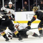 
              Arizona Coyotes right wing Zack Kassian (44) falls to the ice between Vegas Golden Knights' Jonas Rondbjerg (46) and Jake Leschyshyn (15) during the first period of an NHL hockey game Wednesday, Dec. 21, 2022, in Las Vegas. (AP Photo/Chase Stevens)
            