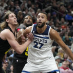 
              Utah Jazz forward Kelly Olynyk, left, and Minnesota Timberwolves center Rudy Gobert (27) look for a rebound during the first half of an NBA basketball game Friday, Dec. 9, 2022, in Salt Lake City. (AP Photo/Rick Bowmer)
            