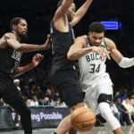 
              Milwaukee Bucks forward Giannis Antetokounmpo (34) loses control of the ball as Brooklyn Nets forward T.J. Warren and forward Kevin Durant (7)defend during the first half of an NBA basketball game, Friday, Dec. 23, 2022, in New York. (AP Photo/Jessie Alcheh)
            