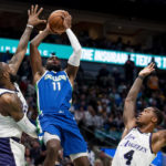 
              Dallas Mavericks forward Tim Hardaway Jr. (11) goes up for a shot as Los Angeles Lakers forward LeBron James and Los Angeles Lakers guard Lonnie Walker IV (4) contest him in the second half of an NBA basketball game in Dallas, Sunday, Dec. 25, 2022. (AP Photo/Emil T. Lippe)
            