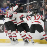 
              Canada forward Laura Stacey, center, celebrates with teammates after scoring during the second period of a Rivalry Series hockey game against the United States Monday, Dec. 19, 2022, in Los Angeles. (AP Photo/Ashley Landis)
            