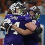 
              Washington wide receiver Jalen McMillan, left, celebrates with teammate Corey Luciano (74) after scoring a touchdown against Texas during the second half of the Alamo Bowl NCAA college football game in San Antonio, Thursday, Dec. 29, 2022. (AP Photo/Eric Gay)
            