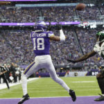 
              Minnesota Vikings wide receiver Justin Jefferson (18) catches a 10-yard touchdown pass ahead of New York Jets cornerback D.J. Reed (4) during the second half of an NFL football game, Sunday, Dec. 4, 2022, in Minneapolis. (AP Photo/Andy Clayton-King)
            
