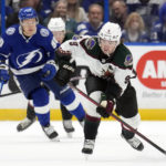 
              Arizona Coyotes right wing Clayton Keller (9) breaks out ahead of Tampa Bay Lightning center Vladislav Namestnikov (90) during the first period of an NHL hockey game Saturday, Dec. 31, 2022, in Tampa, Fla. (AP Photo/Chris O'Meara)
            