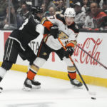 
              Anaheim Ducks right wing Frank Vatrano (77) passes while defended by Los Angeles Kings defenseman Jordan Spence (53) during the first period of an NHL hockey game Tuesday, Dec. 20, 2022, in Los Angeles. (AP Photo/Ashley Landis)
            