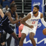 
              Los Angeles Clippers guard Paul George drives against Orlando Magic center Bol Bol during the first half of an NBA basketball game Wednesday, Dec. 7, 2022, in Orlando, Fla. (AP Photo/Scott Audette)
            