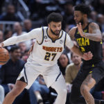 
              Denver Nuggets guard Jamal Murray, left, is defended by Utah Jazz guard Nickeil Alexander-Walker during the second half of an NBA basketball game Saturday, Dec. 10, 2022, in Denver. (AP Photo/David Zalubowski)
            