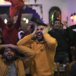 
              Morocco fans react as they watch the semifinal match against France in the World Cup, in Barcelona, Spain Wednesday, Dec. 14, 2022. (AP Photo/Emilio Morenatti)
            