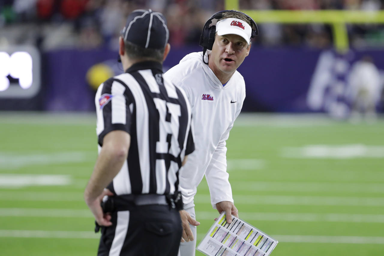 Mississippi coach Lane Kiffin talks with an official about a penalty call during the first half of ...