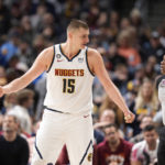 
              Denver Nuggets center Nikola Jokic, left, argues after he was called for a foul by referee Tre Maddox, right, in the second half of an NBA basketball game against the Miami Heat, Friday, Dec. 30, 2022, in Denver. (AP Photo/David Zalubowski)
            
