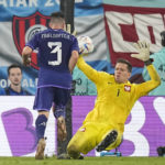 
              Poland's goalkeeper Wojciech Szczesny, right, makes a save in front of Argentina's Nicolas Tagliafico during the World Cup group C soccer match between Poland and Argentina at the Stadium 974 in Doha, Qatar, Wednesday, Nov. 30, 2022. (AP Photo/Ariel Schalit)
            