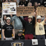 
              Fans hold up signs encouraging Jackson State head football coach Deion Sanders to take the head football coach opening at Colorado in the first half of an NCAA college basketball game as Colorado hosts Arizona State, Thursday, Dec. 1, 2022, in Boulder, Colo. (AP Photo/David Zalubowski)
            