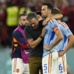 
              Spain's head coach Luis Enrique, left, embraces Sergio Busquets after the penalty shootout at the World Cup round of 16 soccer match between Morocco and Spain, at the Education City Stadium in Al Rayyan, Qatar, Tuesday, Dec. 6, 2022. (AP Photo/Luca Bruno)
            
