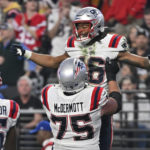 
              New England Patriots wide receiver Jakobi Meyers (16) is congratulated after a two-point conversion reception during the second half of an NFL football game between the New England Patriots and Las Vegas Raiders, Sunday, Dec. 18, 2022, in Las Vegas. (AP Photo/David Becker)
            