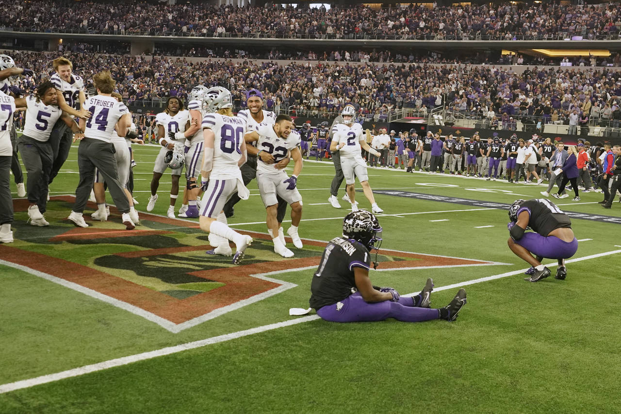 Kansas State players celebrate as TCU's Tre'Vius Hodges-Tomlinson (1) sits in the end zone with Dee...