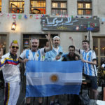 
              Fans of Argentina cheer for their team in Souq Waqif market in Doha, Qatar, Thursday, Dec. 15, 2022. Argentina will face France in the World Cup final match on Dec. 18. (AP Photo/Andre Penner)
            