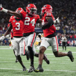 
              Georgia defensive back Malaki Starks (24) reacts as Georgia defensive back Christopher Smith (29) returns a blocked LSU field goal attempt for a touchdown in the first half of the Southeastern Conference Championship football game Saturday, Dec. 3, 2022 in Atlanta. (AP Photo/John Bazemore)
            