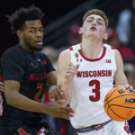 
              Wisconsin's Connor Essegian (3) drives against Maryland's Jahari Long (2) during the first half of an NCAA college basketball game Tuesday, Dec. 6, 2022, in Madison, Wis. (AP Photo/Andy Manis)
            