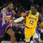 
              Los Angeles Lakers guard Kendrick Nunn (12) drives against Phoenix Suns forward Josh Okogie during the first half of an NBA basketball game, Monday, Dec. 19, 2022 in Phoenix. (AP Photo/Rick Scuteri)
            