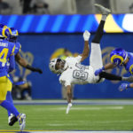 
              Las Vegas Raiders wide receiver Keelan Cole (84) is hauled down by Los Angeles Rams safety Taylor Rapp, right, during the second half of an NFL football game Thursday, Dec. 8, 2022, in Inglewood, Calif. (AP Photo/Marcio Jose Sanchez)
            