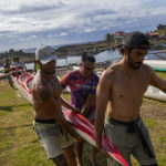 
              Rapanuis crew members carry their canoe during a training session for the Hoki Mai challenge, a voyage — covering almost 500 kilometers, or about 300 miles across a stretch of the Pacific Ocean, in Rapa Nui, a territory that is part of Chile and is better known as Easter Island, Thursday, Nov. 24, 2022. The athletes have been training six days a week since mid-September, preparing for a voyage that will take them from Rapa Nui to Motu Motiro Hiva. (AP Photo/Esteban Felix)
            