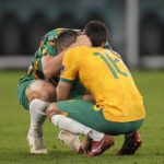 
              Australia's Aziz Behich is comforted after losing the World Cup round of 16 soccer match between Argentina and Australia at the Ahmad Bin Ali Stadium in Doha, Qatar, Saturday, Dec. 3, 2022. (AP Photo/Lee Jin-man)
            