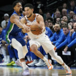 
              Phoenix Suns guard Devin Booker (1) drives against Dallas Mavericks guard Spencer Dinwiddie (26) during the first quarter of an NBA basketball game in Dallas, Monday, Dec. 5, 2022. (AP Photo/LM Otero)
            