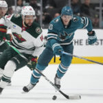 
              Minnesota Wild left wing Jordan Greenway (18) and San Jose Sharks left wing Evgeny Svechnikov (10) chase the puck during the first period of an NHL hockey game in San Jose, Calif., Thursday, Dec. 22, 2022. (AP Photo/Godofredo A. Vásquez)
            